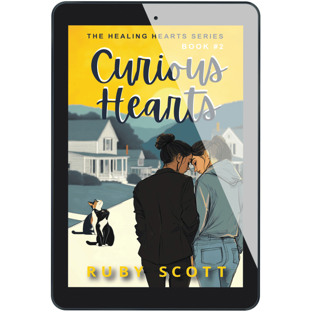 Tablet display of the eBook Curious Hearts by lesbian romance author Ruby Scott, showing two women standing close with a cat nearby in a small-town setting.