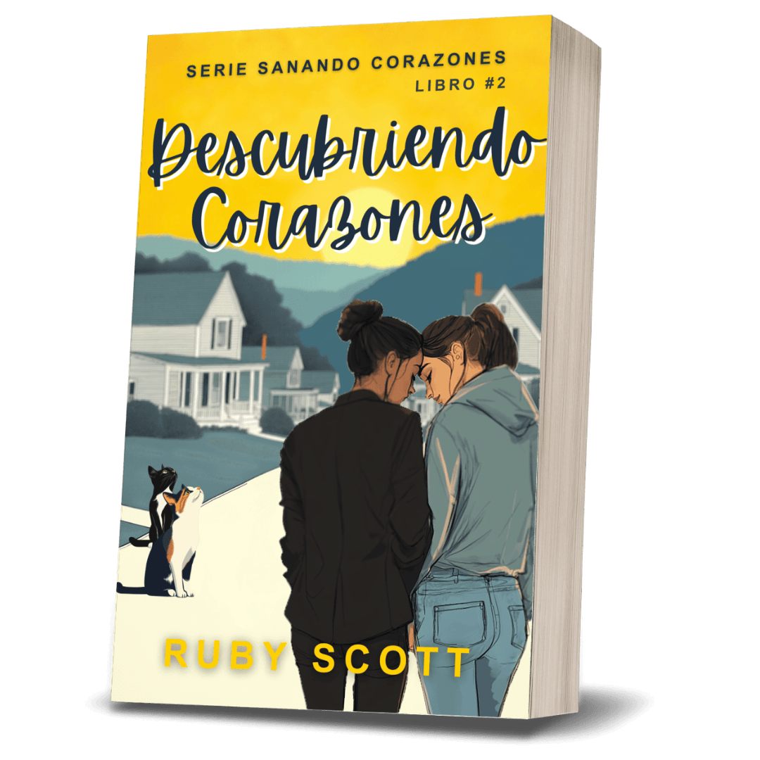 Spanish edition paperback book of 'Descubriendo corazones!' by Ruby Scott, featuring a yellow top section with the title and an illustration of a couple embracing on a beach with a dog.