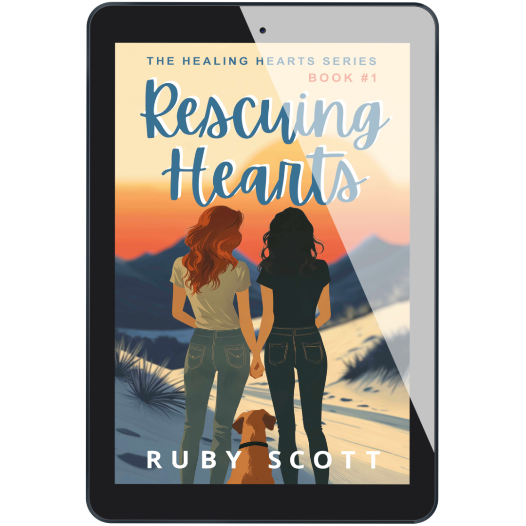 Ebook cover of Rescuing Hearts displayed on a tablet, showing a sapphic couple hand in hand with a dog at sunset, from lesbian romance fiction author Ruby Scott.

