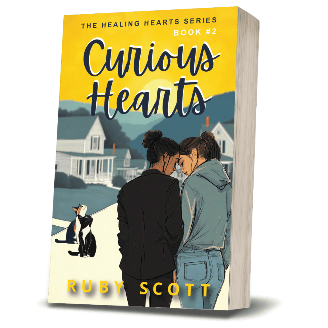 3D paperback of Curious Hearts by lesbian romance fiction author Ruby Scott, featuring two women leaning forehead-to-forehead with a cat in the foreground, set in a peaceful small-town neighbourhood.