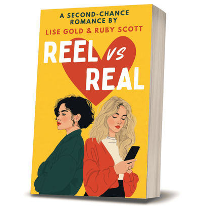 3D paperback image of Reel vs Real, a lesbian second-chance romance by Lise Gold and Ruby Scott, showing two women—one with dark hair and the other blonde—on a bright yellow cover with a heart motif