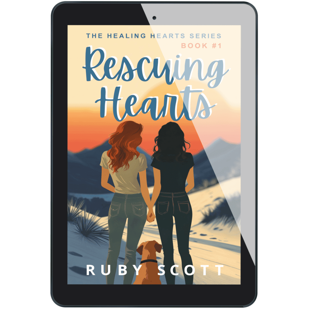 Tablet display of the eBook Rescuing Hearts by lesbian romance author Ruby Scott, showing two women holding hands at sunset with a dog beside them, in a mountainous desert setting