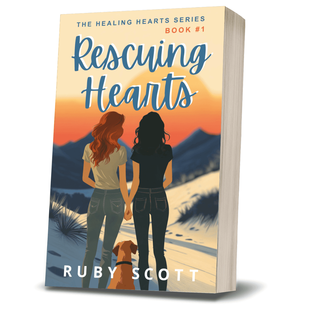 3D paperback of Rescuing Hearts by lesbian romance fiction author Ruby Scott, showing two women holding hands as they walk toward a sunset with a golden retriever beside them, set in a desert landscape.