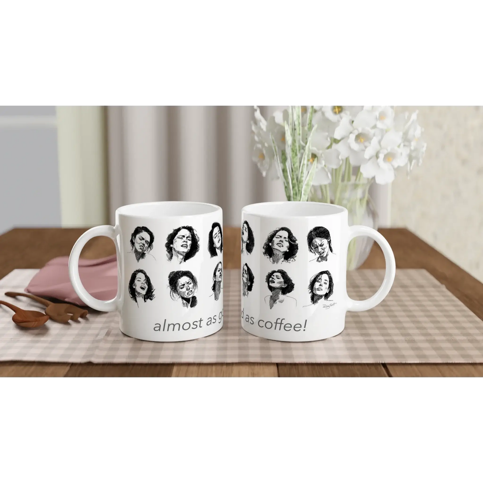 White ceramic mug featuring diverse women and the phrase 'almost as good as coffee!' on a wooden table.