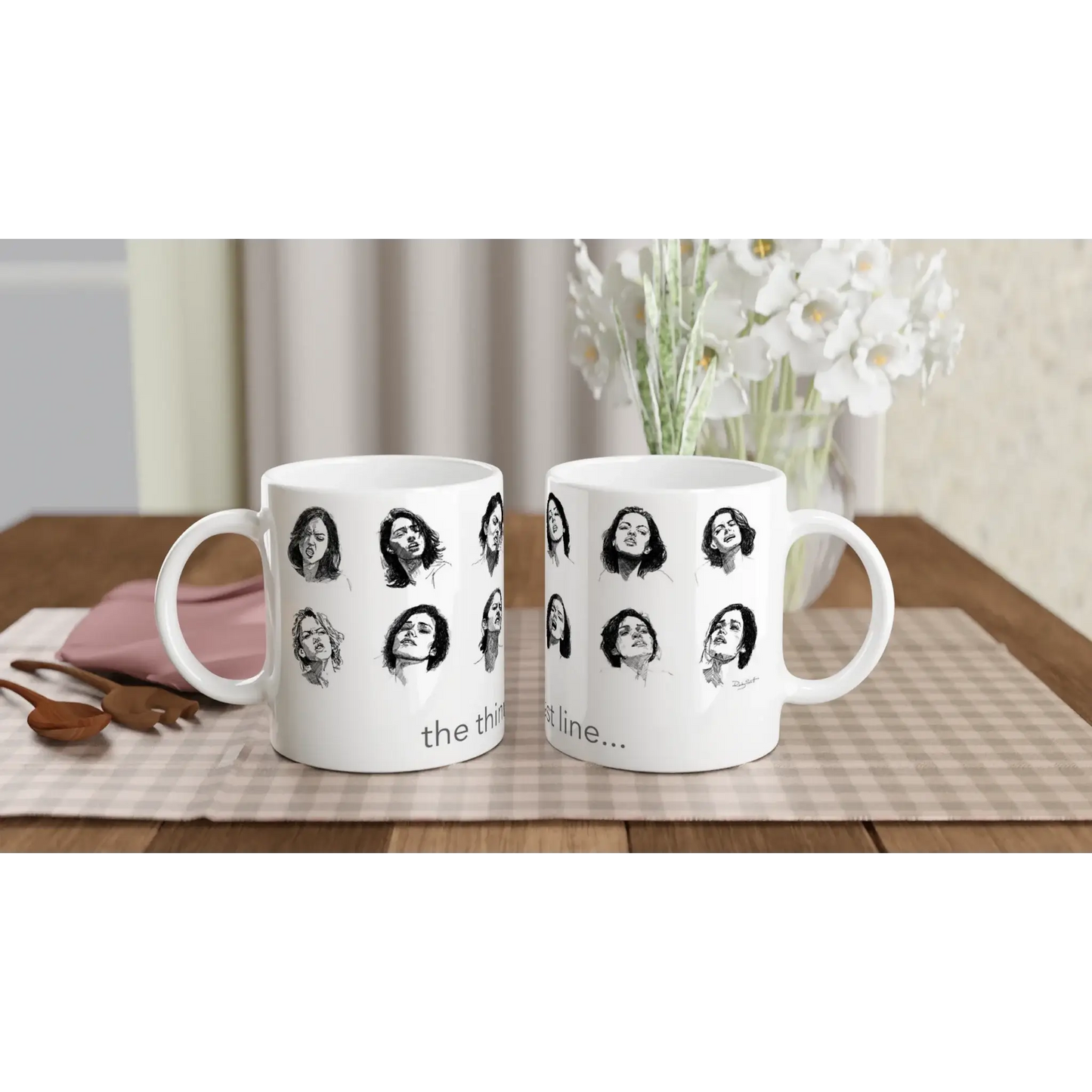 Smut reader mug featuring black and white illustrated faces with the phrase “the thinnest line…”, shown in a front-facing studio mock-up.