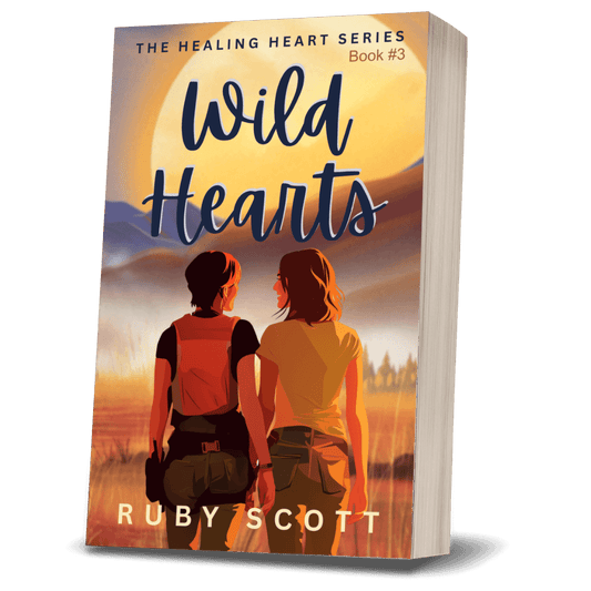 Cover of Wild Hearts, a signed paperback featuring two women in a sunset landscape, part of the Healing Heart series.